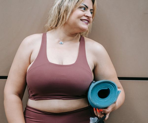 Neatly arranged yoga mat, water bottle, and comfortable clothes.